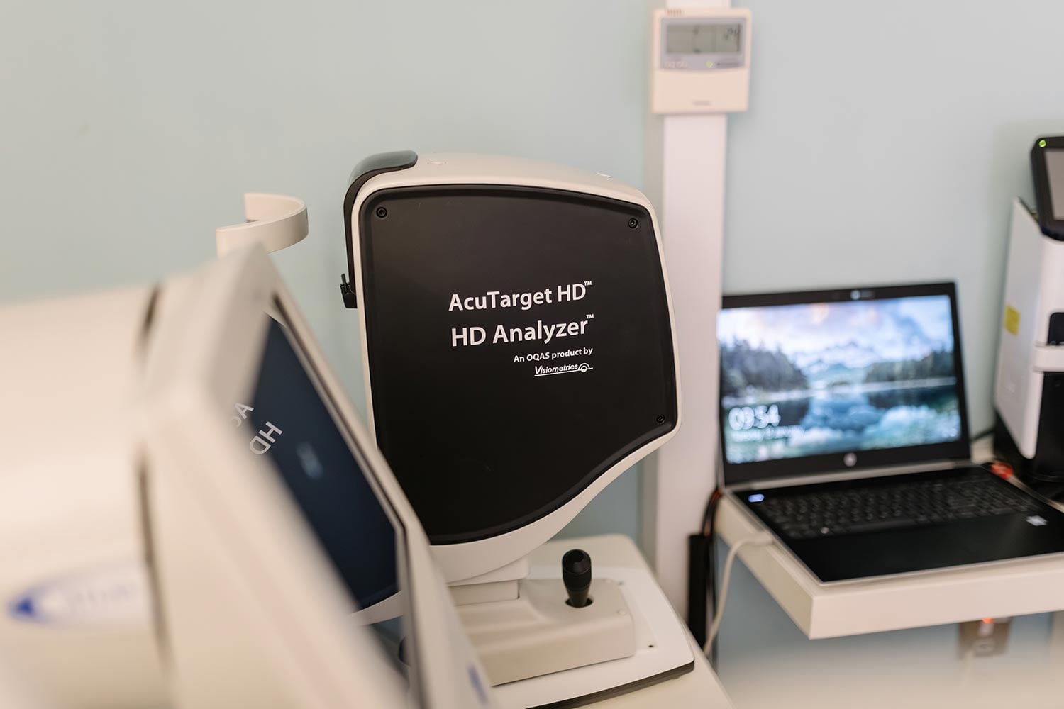 AcuTarget HD HD Analyzer in a medical exam room with a nearby laptop on a desk