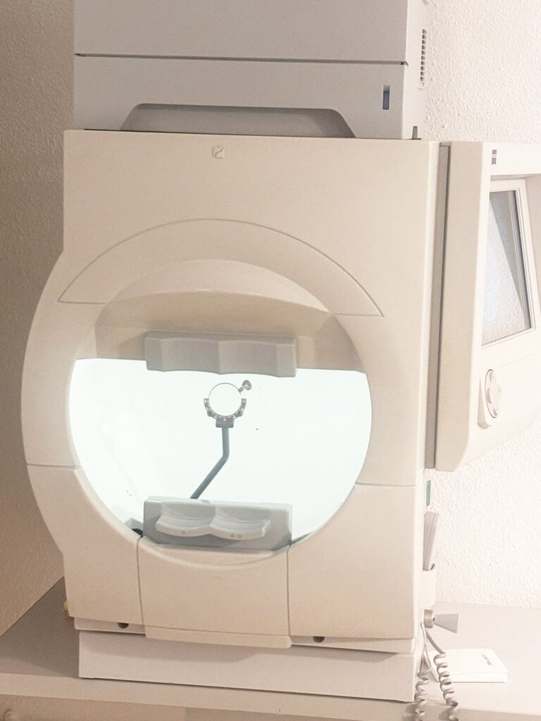 MRI scanner with a circular opening and patient table ready for a scan.
